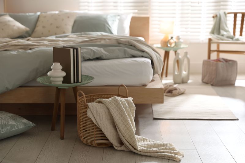 light blue and tan toned bedroom with a cozy bed and hardwood floor
